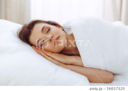 Beautiful young woman sleeping while lying in her bed. Concept of pleasant and rest reinstatement 56637320