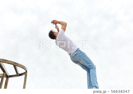 young ambitious man practicing parkour young ambitious man practicing parkour 56638347