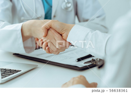 Doctor and patient shaking hands, close-up. Medicine, healthcare and trust concept 56638361