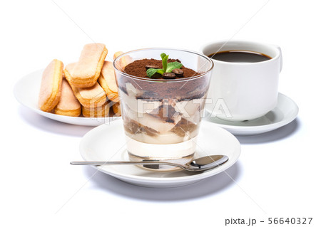 Classic tiramisu dessert in a glass cup, savoiardi cookies and espresso coffee on white background Classic tiramisu dessert in a glass cup, savoiardi cookies and espresso coffee on white background 56640327