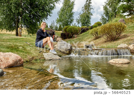 Golf course, a beautiful girl getting ready to hit the ball. Lifestyle concept, golf concept 56640525