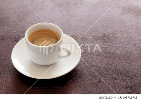 Hot cup of espresso coffee on a table Hot cup of espresso coffee on a table 56644243