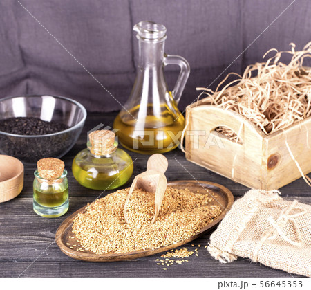 The Sesame oil in glass and seeds The Sesame oil in glass and seeds 56645353