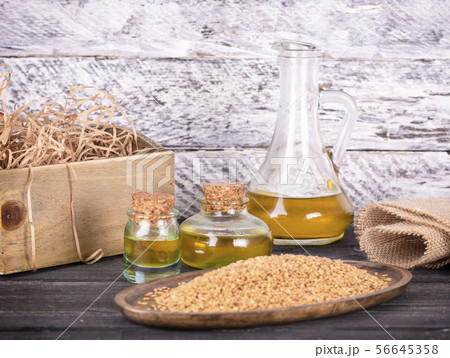 The Sesame oil in glass and seeds The Sesame oil in glass and seeds 56645358