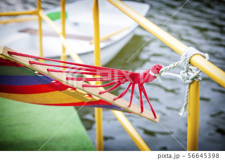 The backyard rope hammock held by metal railing The backyard rope hammock held by metal railing 56645398