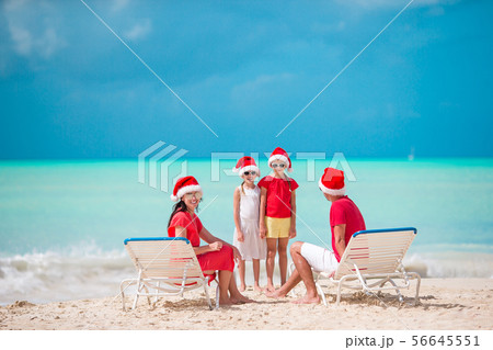Happy family with two kids in Santa Hat on summer vacation 56645551