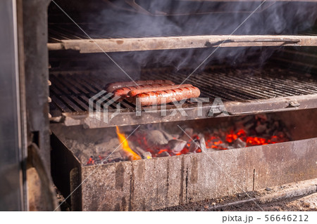 food, delicious and craft concept - grilled sausage on the flaming grill 56646212