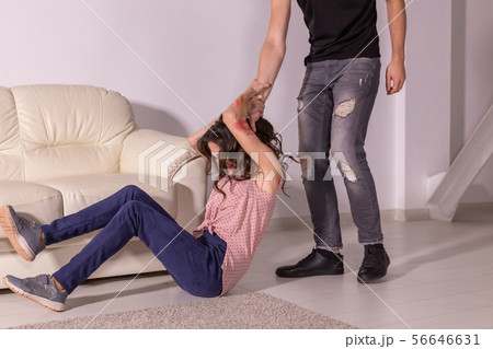 Domestic violence, abuse and victim concept - aggressive man dragging helpless woman by hair 56646631