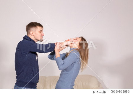 People and abuse concept - Portrait of angry young man try to hit the woman 56646696