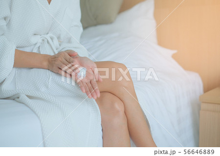 Woman applying moisturizing cream/lotion on hands, 56646889