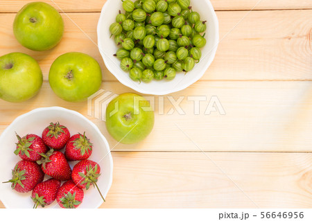 Natural organic food background with copy space. Fruits and berries on wooden table. Natural organic food background with copy space. Fruits and berries on wooden table. 56646956