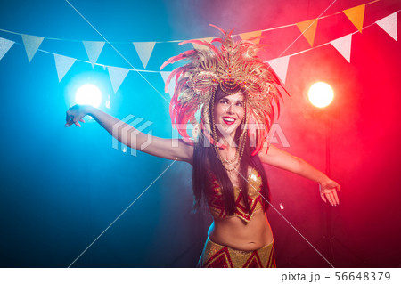 Carnival, dancer and holiday concept - Beauty brunette woman in cabaret suit and headdress with Carnival, dancer and holiday concept - Beauty brunette woman in cabaret suit and headdress with 56648379