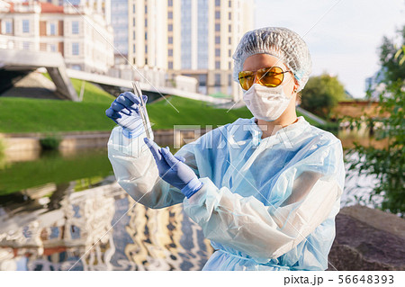 female ecologist or epidemiologist checks water 56648393