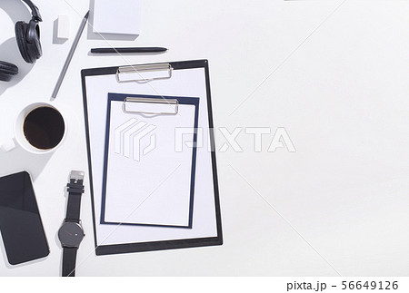 Top view of black and white office supplies with clippers on white Top view of black and white office supplies with clippers on white 56649126