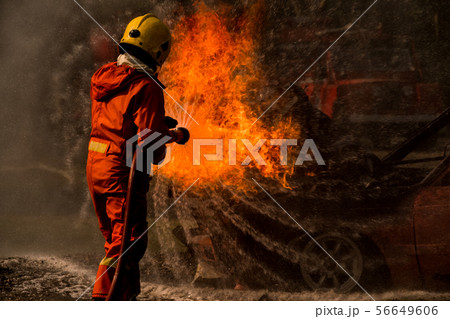 Firefighter splash water to fire hydrant 56649606