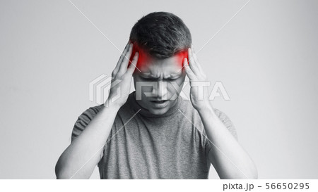 Young man with strong headache, monochrome photo 56650295