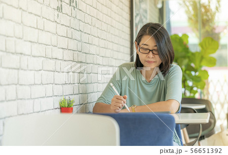 Portrait woman using tablet in coffee shop. Portrait woman using tablet in coffee shop. 56651392
