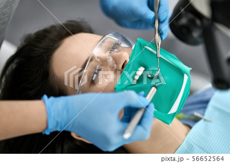 Pretty woman's teeth treatment in dental clinic 56652564