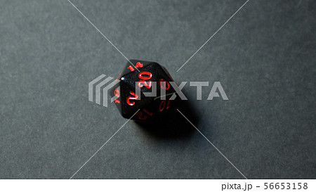 A twenty-sided dice thrown onto a white surface. A twenty-sided dice thrown onto a white surface. 56653158