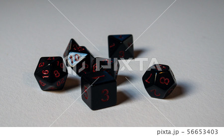 A twenty-sided dice thrown onto a white surface. A twenty-sided dice thrown onto a white surface. 56653403