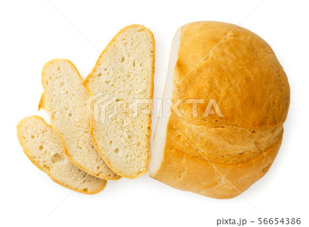 Loaf of bread cut into pieces on a white. The view Loaf of bread cut into pieces on a white. The view 56654386