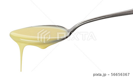 Pouring condensed milk isolated on white background 56656367