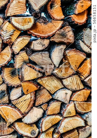 Big wall of stacked wood logs showing natural discoloration 56658151