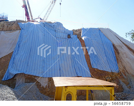 Temporary slope protection using plastic sheets 56658759
