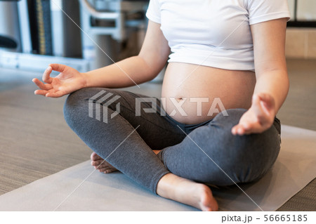 Active pregnant woman exercise in fitness center. Active pregnant woman exercise in fitness center. 56665185