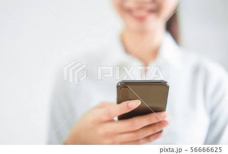 Close-up of hands using smartphone on wooden table Close-up of hands using smartphone on wooden table 56666625