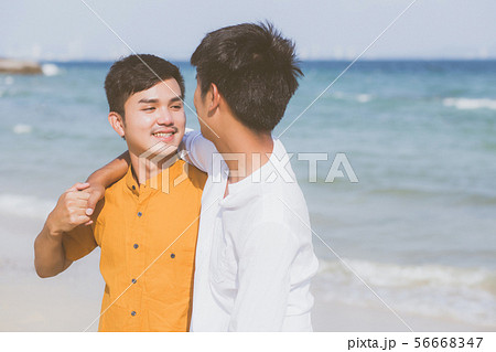 Homosexual young asian couple standing on beach Homosexual young asian couple standing on beach 56668347