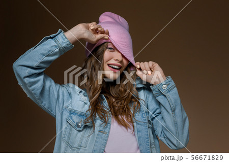 girl in jeans jacket , a pink hat and stylish glasses 56671829
