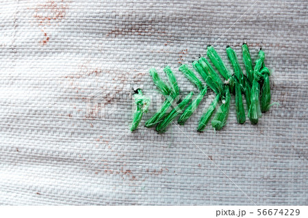 Plastic rope sewing at the tear of woven bag Plastic rope sewing at the tear of woven bag 56674229