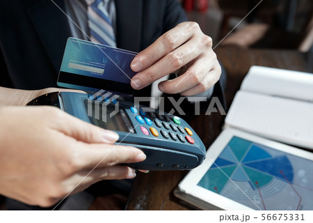 Businessman swiping credit card 56675331