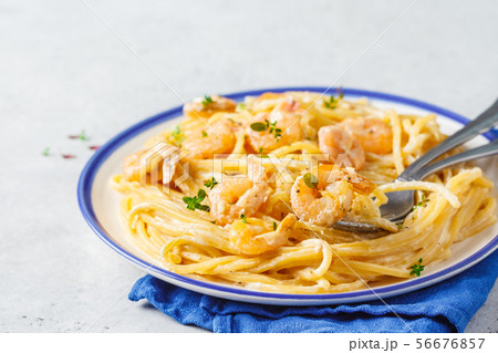 Shrimp pasta with cream and herbs in white plate Shrimp pasta with cream and herbs in white plate 56676857