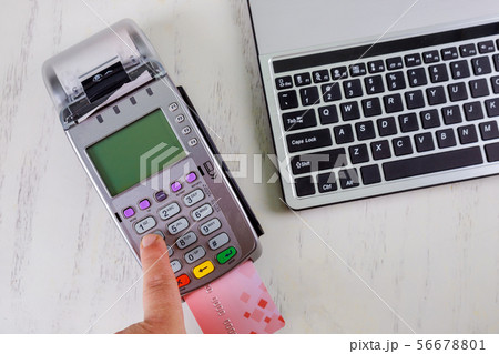 Man tapping a contact less credit card paying of Man tapping a contact less credit card paying of 56678801