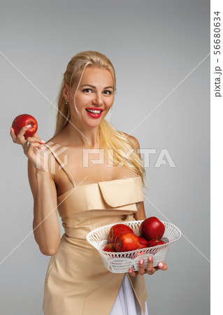 young woman holding red apple young woman holding red apple 56680634