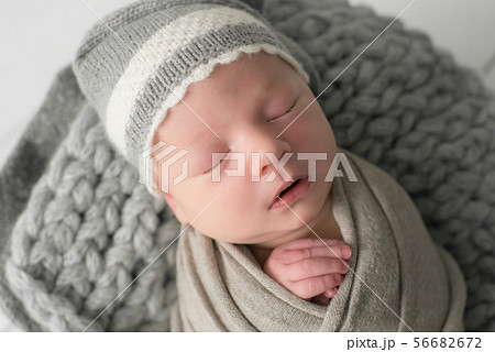 Sweet newborn baby sleeps in a basket 56682672