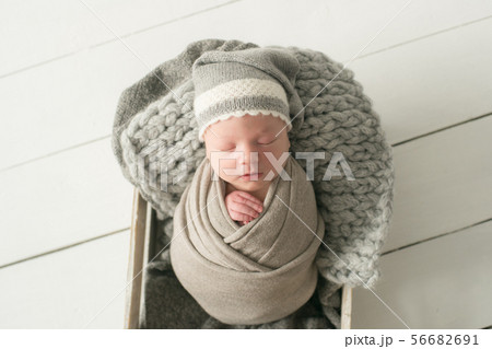 Sweet newborn baby sleeps in a basket 56682691