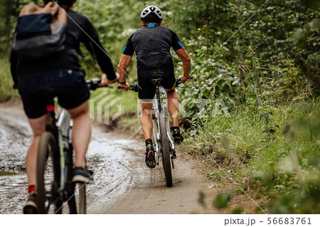 back two cyclists riding mountain bike 56683761