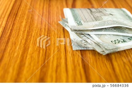 Stolen money india rupee note laying on table.  56684336