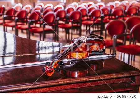 Violin lies on piano on backround of blurred hall 56684720