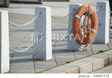 岸辺の柵に掛けられた救命浮き輪 56685378