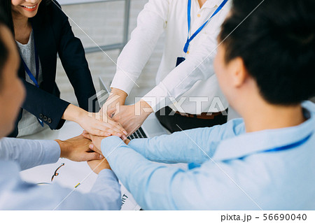 Business people showing unity and collaboration gesture 56690040