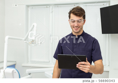 Dental polymerization lamp with UV light and laser. Stomatological instrument in the dentist clinic 56690343
