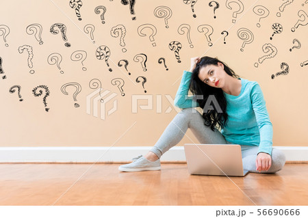 Small question marks with woman using a laptop 56690666