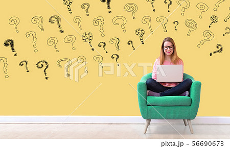 Small question marks with woman using a laptop 56690673