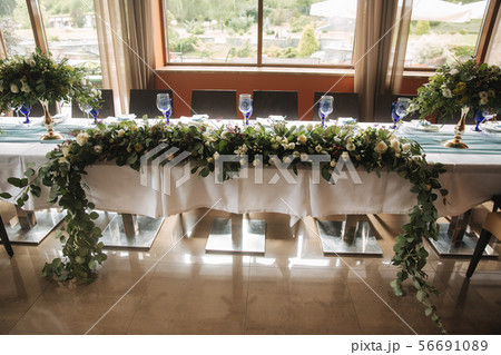 Decorated table for wedding celebration. Bright restaurand with a lot of windows 56691089