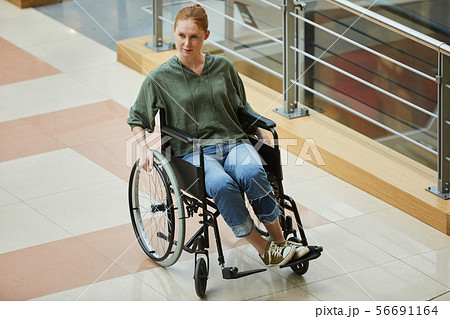 Woman going on wheelchair Woman going on wheelchair 56691164