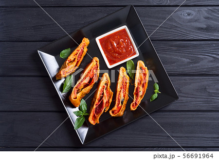 Pizza roll stromboli with cheese salami olives and 56691964